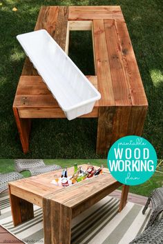 a wooden work bench sitting on top of a grass covered field next to a picnic table