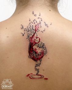 the back of a woman's neck with music notes and a glass of wine