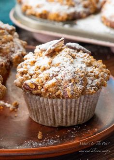 several muffins with crumbs and butter on top