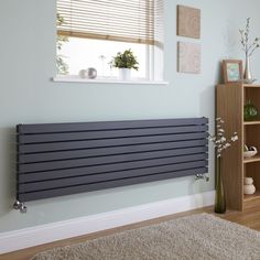 a radiator in the corner of a room with a rug on the floor