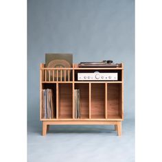 an old record player on top of a wooden shelf