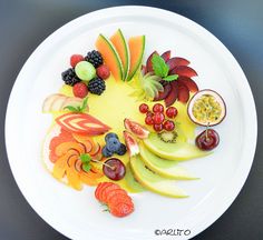 a white plate topped with cut up fruit