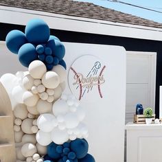 balloons and baseballs are on display in front of a building