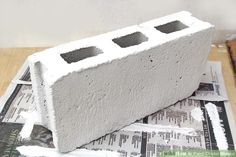 a cement block sitting on top of newspaper