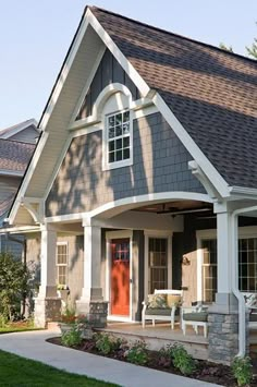 a gray house with white trim and red door