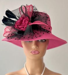 The featured hat is a fuchsia  straw hat with a black crinoline flower, black netting, black feathers and a fuchsia center fabric flower. This hat is so eye popping and gorgeous  it's a must have for any woman who loves hats. This  hat is a beautiful church hat or a Kentucky Derby Hat.  Also perfect  for an Easter Hat, Tea Party hat,Wedding Party Hat, Fancy Dress Hat , Downton Abby hat and any other special occasion. Brim:   3" Rise:   4" Size:   22" Pink Fedora Sun Hat For Party, Pink Flat Brim Sun Hat For Party, Pink Fedora Sun Hat For Kentucky Derby, Pink Fedora Straw Hat For Kentucky Derby, Pink Fedora Hat For Wedding, Pink Fedora For Wedding, Pink Mini Hats With Flat Brim For Party, Pink Wide Brim Sun Hat For Party, Pink Flat Brim Mini Hats For Party