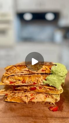 a stack of quesadillas with guacamole on the top and bottom