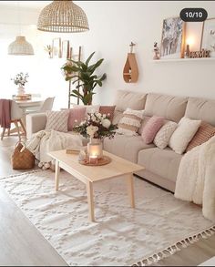 a living room filled with lots of furniture next to a white rug on top of a hard wood floor