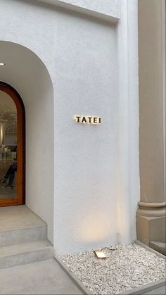 an entrance to a building with the name tatei on it's front door