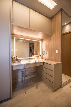 a bathroom with a vanity, mirror and stool in it's center area is shown