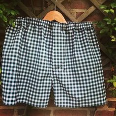 a black and white checkered shorts hanging on a brick wall