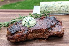 a piece of steak on a wooden cutting board