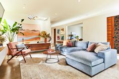 a living room filled with furniture and a painting on the wall