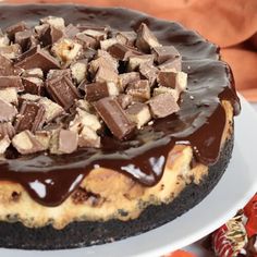 a chocolate covered cake sitting on top of a white plate