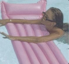 a woman laying on an inflatable pool float