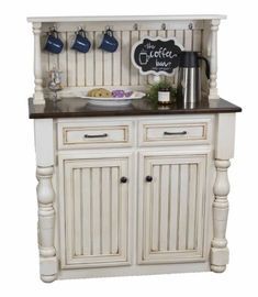 a white cabinet with black counter top and drawers