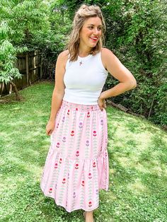 Transform your summer wardrobe with our Pink Tulip Tiered Skirt. This playful and fun piece features a stunning pattern and beautiful colors, perfect for bringing a pop of color to any outfit. With a smocked waist and lining, it not only looks great but also offers a comfortable fit. A must-have for any fashion-forward individual looking to make a statement! Fit is true to size. Emily is 5'8" wearing a medium. Small (0-4) Medium (6-8) Large (10-12) XL (14-16) Dress Layer, Pink Tulips, Tier Skirt, Tiered Skirt, Summer Wardrobe, Tulips, Beautiful Colors, Looks Great, Must Haves