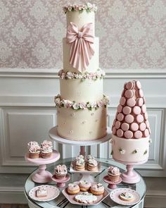 a table topped with lots of cakes and cupcakes