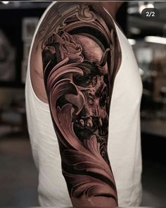 a man's arm with a skull and waves tattoo on the left side of his arm