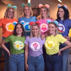 a group of women standing next to each other wearing t - shirts with cartoon characters on them