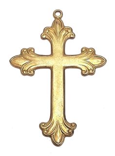 an ornate gold cross pendant on a white background