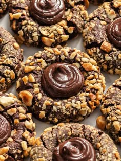 there are many cookies with chocolate frosting and nuts