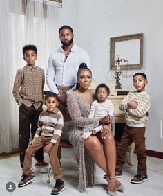 the family is posing for a photo in their living room