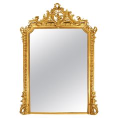 an ornate gold framed mirror against a white background