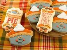 three decorated cookies on a plate with the words how to make pumpkin pie cookies written in frosting