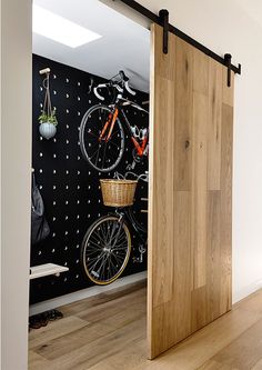 an image of a bike mounted to the side of a wooden door in a room