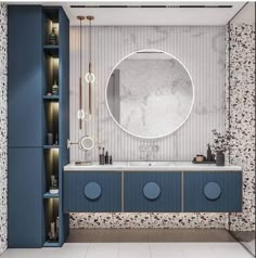 a bathroom with blue cabinets and a round mirror on the wall above the sink,