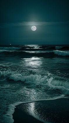 the moon is shining over the ocean waves