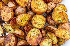 roasted potatoes with herbs and seasoning on a white plate