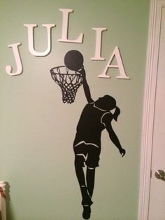 a wall with the name julia painted on it and a basketball going through the hoop