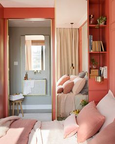 a bedroom with pink walls and white bedding