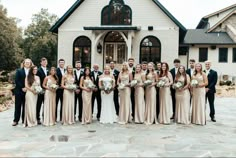 a large group of people standing in front of a house