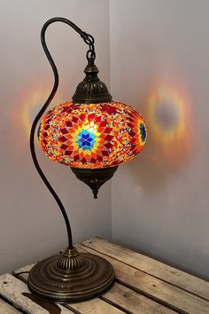 a colorful lamp sitting on top of a wooden table