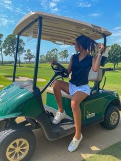 a woman is sitting on a golf cart