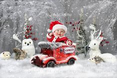 a baby in santa's hat sitting on top of a train surrounded by animals