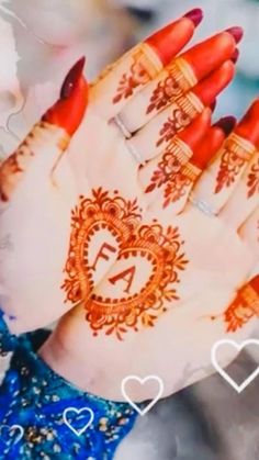 a woman's hand with henna on it and hearts in the middle of her hands