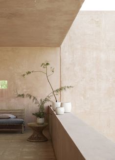 a bed sitting next to a plant in a room