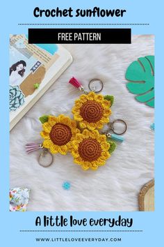 two crochet sunflower keychains are sitting on top of a blanket