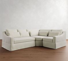 a white couch sitting on top of a hard wood floor