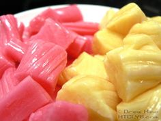 there are many pieces of fruit on the plate and one is cut into cubes