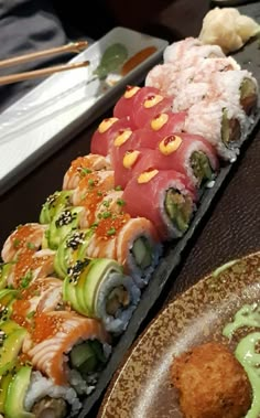 several sushi rolls are lined up on a table