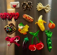 there are many different toy food items on the table