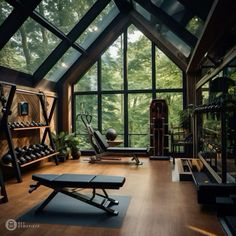 a home gym with lots of exercise equipment and yoga mats on the floor in front of large windows