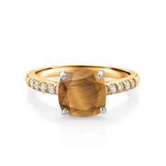 a yellow gold ring with a brown stone and diamonds