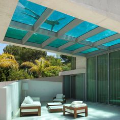 an outdoor living area with couches and chairs