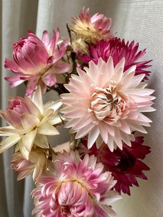 pink and white flowers are in a vase